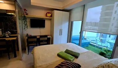 a bedroom with a bed and a view of the ocean at Urban Resort luxury Staycation at Azure Residences Rio Tower in Manila