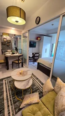 a living room with a couch and a table at Urban Resort luxury Staycation at Azure Residences Rio Tower in Manila