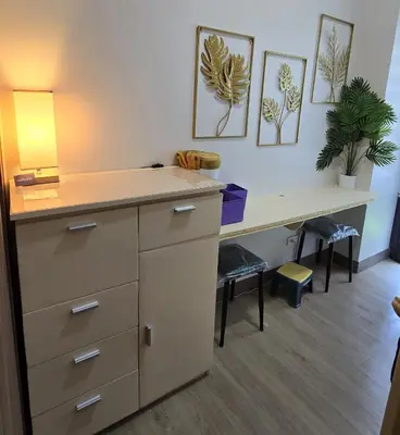 an office with a desk with a lamp and plants at Urban Resort luxury Staycation at Azure Residences Rio Tower in Manila