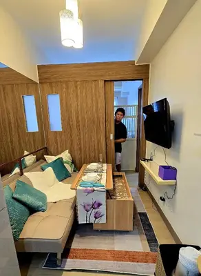 a living room with a couch and a tv at Urban Resort luxury Staycation at Azure Residences Rio Tower in Manila