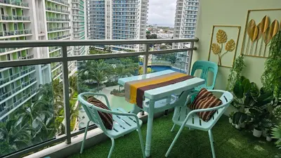 a balcony with a table and chairs on a balcony at Urban Resort luxury Staycation at Azure Residences Rio Tower in Manila