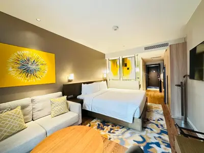 a hotel room with a bed and a couch at Hotel Residences near Makati in Manila