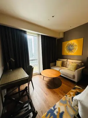 a living room with a couch and a table at Hotel Residences near Makati in Manila