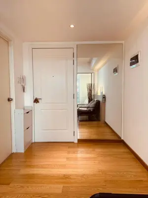 a hallway with a white door and a couch at Azure Urban Resort Residences Maui Tower in Manila