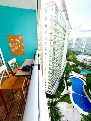 a balcony with a view of a building and a pool at Azure Urban Resort Residences Maui Tower in Manila