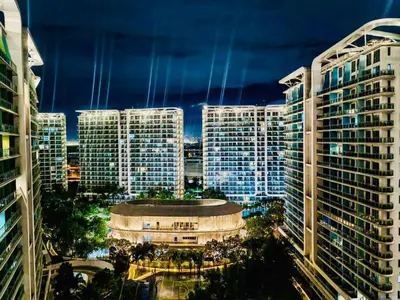 a view of a city at night with tall buildings at Azure Urban Resort Residences Maui Tower in Manila