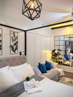 a living room with a bed and a couch at AIR RESIDENCES Makati Netflix plus 200 mbps digital door lock in Manila