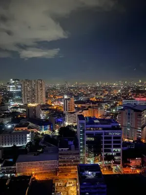 a view of a city at night with lights at AIR RESIDENCES Makati Netflix plus 200 mbps digital door lock in Manila