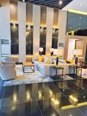 a living room with couches and tables and windows at AIR RESIDENCES Makati Netflix plus 200 mbps digital door lock in Manila
