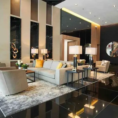 a living room with a white couch and tables at AIR RESIDENCES Makati Netflix plus 200 mbps digital door lock in Manila