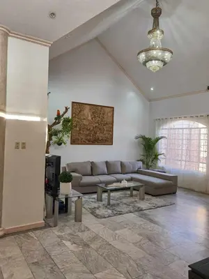 a living room with a couch and a table at Tropical house in Manila