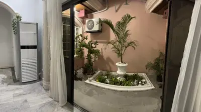 a room with a fountain with plants in it at Tropical house in Manila