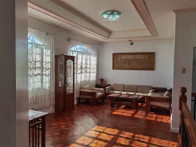 a living room with a couch and a table at Tropical house in Manila