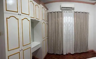 a bathroom with white cabinets and a mirror at Tropical house in Manila