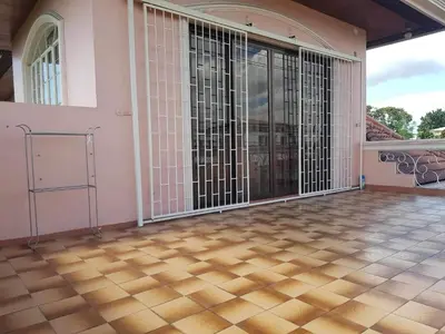an empty room with sliding doors on a house at Tropical house in Manila