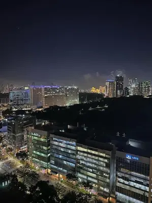 a view of a city at night with buildings at Luxury Bohemian Suite Venice Canal Mall & BGC Views in Manila
