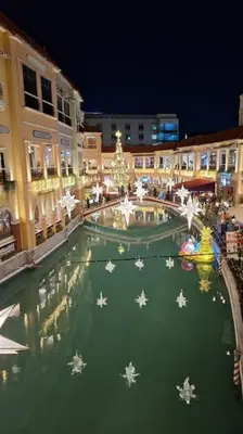 a shopping center with christmas decorations in a city at Luxury Bohemian Suite Venice Canal Mall & BGC Views in Manila