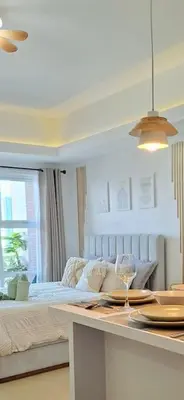 a bedroom with a bed and a table with a wine glass at Luxury Bohemian Suite Venice Canal Mall & BGC Views in Manila