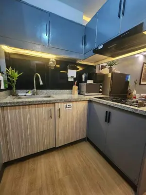 a kitchen with a sink and a counter top at Aura Suites in Imus
