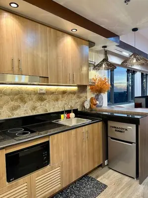 a kitchen with a sink and a stove top oven at Prime End Sunset View Unit in Makati in Manila