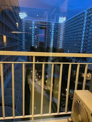 a balcony with a view of a city at night at Cozy Staycation by Ayumi in Manila