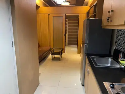 a small kitchen with a sink and a refrigerator at Cozy Staycation by Ayumi in Manila