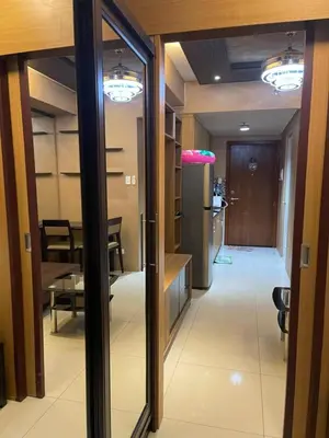 a hallway with a door leading to a dining room at Cozy Staycation by Ayumi in Manila