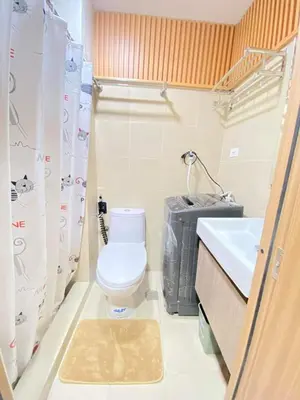 a small bathroom with a toilet and a sink at Comfystay at Shore Residences in Manila