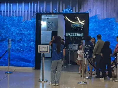 a person taking a picture of a large blue exhibit at Shore Family Suite 2 beds for 4 pax TV Netflix WiFi Near MOA NAIA 9116 in Manila