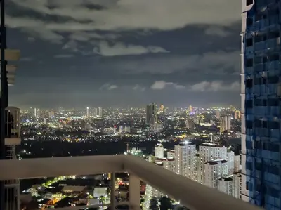 a view of a city at night from a building at 1BR Condotel with Balcony at SM Light Residences #LT10 in Manila