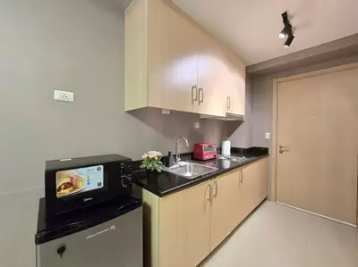 a kitchen with a sink and a microwave at 1BR Condotel with Balcony at SM Light Residences #LT10 in Manila
