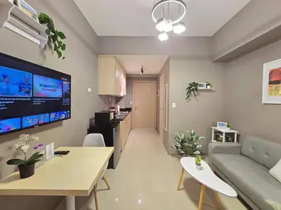 a living room with a couch and a table at 1BR Condotel with Balcony at SM Light Residences #LT10 in Manila