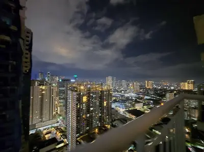 a view of a city skyline at night at 1BR Condotel with Balcony at SM Light Residences #LT10 in Manila