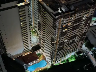 an overhead view of a tall building with a pool at 1BR Condotel with Balcony at SM Light Residences #LT10 in Manila