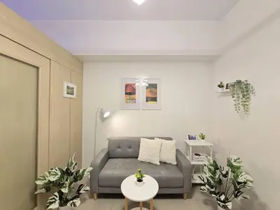 a living room with a couch and a table at 1BR Condotel with Balcony at SM Light Residences #LT11 in Manila