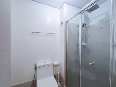 a bathroom with a toilet and a glass shower at 1BR Condotel with Balcony at SM Light Residences #LT11 in Manila