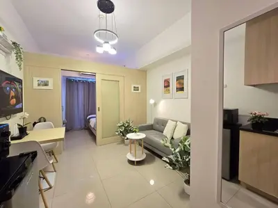 a living room with a couch and a table at 1BR Condotel with Balcony at SM Light Residences #LT11 in Manila