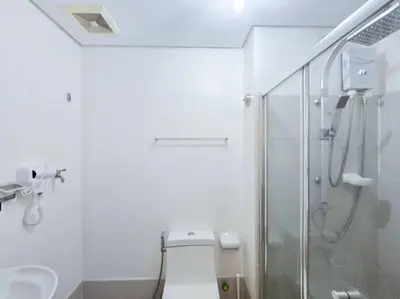 a bathroom with a toilet and a glass shower at 1BR Condotel with Balcony at SM Light Residences #LT11 in Manila