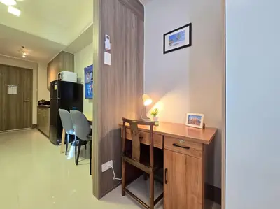 a small office with a desk and chairs in a room at 1BR Condotel with Balcony at FAME Residences #FM63 in Manila