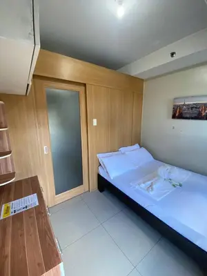 a bedroom with a large bed and a window at P3K Shell Staycation in Manila