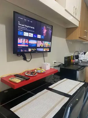 a flat screen tv on a wall in a kitchen at P3K Shell Staycation in Manila