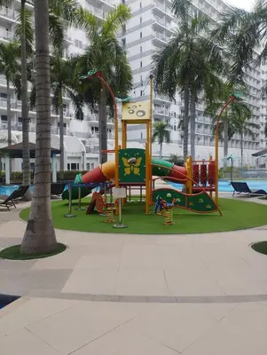 a playground in a park with palm trees at P3K Shell Staycation in Manila