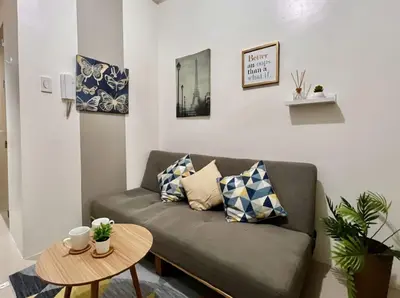 a living room with a couch and a table at Mall of Asia - Aseana Pasay Cheap Accommodation in Manila