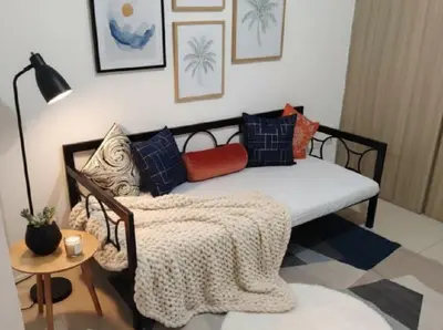 a couch with a blanket on it in a living room at Mall of Asia - Aseana Pasay Cheap Accommodation in Manila