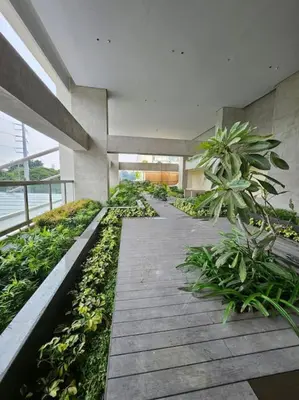 a building with a walkway with plants in it at Luxury Apartment at Park Mckinley West suite 2 in Manila