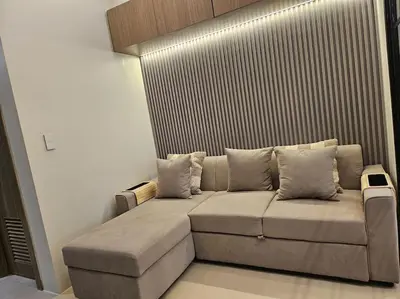a couch sitting in a living room at Luxury Apartment at Park Mckinley West suite 2 in Manila