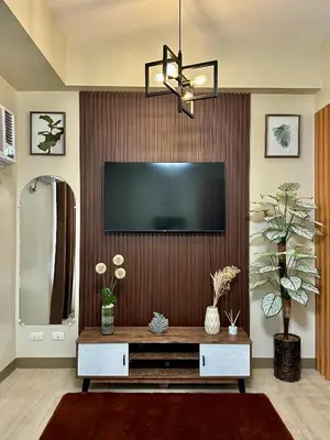 a living room with a flat screen tv on a wall at The Verdin in General Trias