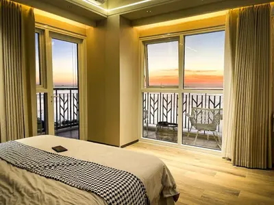 a bedroom with a bed and a large window at Luxury 1BR beside Okada Manila in Manila