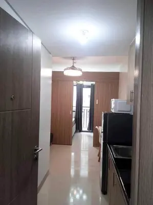 a room with a kitchen with a stove and a microwave at Ocean Room 677 Shore 2 Tower 3 MOA Complex, Pasay City in Manila