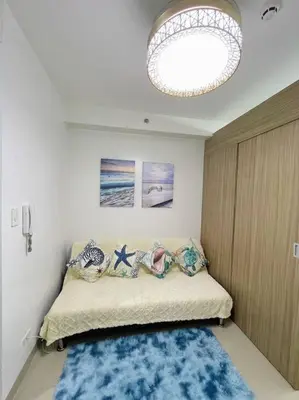 a bedroom with a bed with a blue rug at Ocean Room 677 Shore 2 Tower 3 MOA Complex, Pasay City in Manila